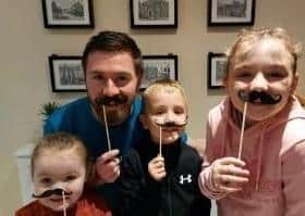Cancer prevention officer Anthony Stuart and his children Molly (9), Sean (7) and Roisin (4) are encouraging men here to take part in the Cancer Focus NI Cash for Tache fundraiser and help raise awareness of men’s health during November.
