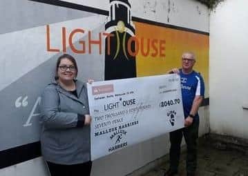Ian Simpson (Mallusk Harriers) presented Cecilia Rice (Lighthoue) with cheque for £2,040.70.