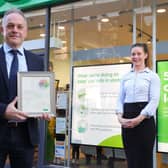 Stuart Douglas receiving his long service certificate from Nikki Gardiner, Specsavers regional relationship manager in Northern Ireland.