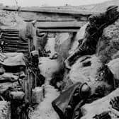 A  British soldier keeps watch on 'No-Man's land' as his comrades sleep in a captured German trench at Ovillers, near Albert, during the Battle of the Somme in 1916.