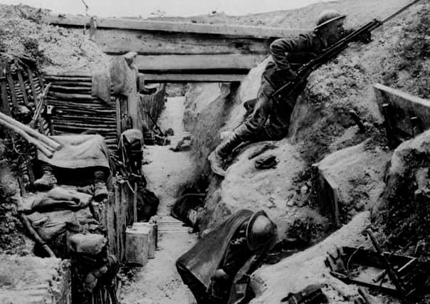 A  British soldier keeps watch on 'No-Man's land' as his comrades sleep in a captured German trench at Ovillers, near Albert, during the Battle of the Somme in 1916.