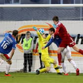 Linfield goalkeeper Chris Johns gets a crucial block on Paddy McNally’s late header to protect the 2-1 lead. Pic by Pacemaker.