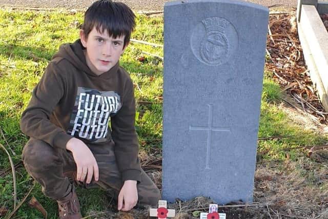 Cadet Peter Robinson placed poppy crosses in Glenarm and Larne Main Cemetery.