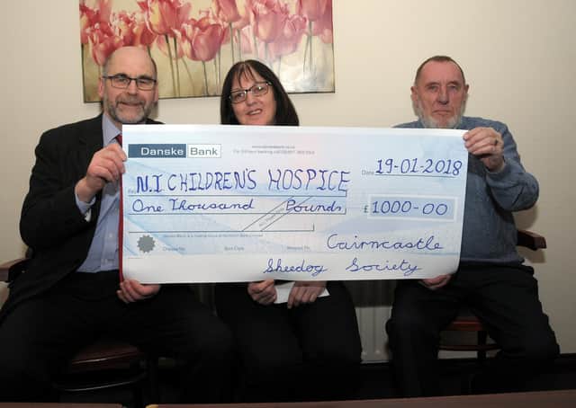 Cairncastle Sheepdog Society secretary, Shaw Beggs and Jackie Atcheson presenting a £1,000 cheque to NI Children’s Hospice fundraiser, Anne McVeigh at the final dinner in January 2018. Picture: Larne Times archive
