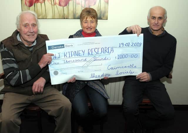 Ben Stewart and Cairncastle Sheepdog Society treasurer, Robert Stewart present Lorraine Harper of Kidney Research NI with a £1,000 cheque from the Cairncastle Sheepdog Society at the final dinner in January 2018. Picture: Larne Times archive