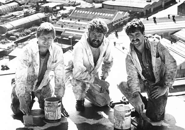 Three workmen hard at work on the Harland and Wolff cranes in July 1983. The City Hospital and Churchill House can clearly be seen from this breathtaking photograph over Belfast. What a view! Picture: News Letter archives