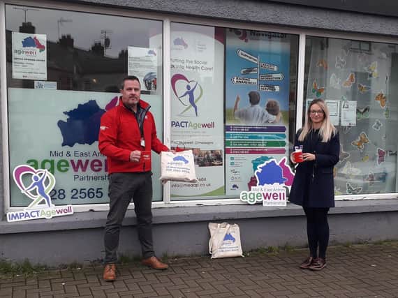 Stay Well at Home: firmus energy natural gas advisor Damien Dineen is pictured delivering 150 mugs to Mid and East Antrim Agewell Partnership team leader, Sarah McLaughlin.