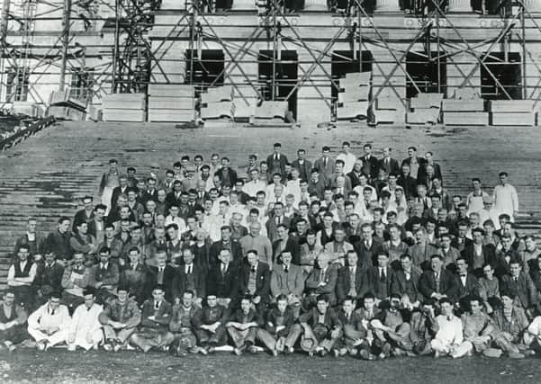 Some of those involved in the construction of Parliament Buildings at Stormont, Belfast. Does anyone recognise anyone in this old photo? Did anyone in your family help build Stormont? Get in touch, email: darryl.armitage@jpimedia.co.uk. Picture: News Letter archives