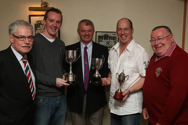 Club director of Cricket Billy Henderson (centre), presents trophies at the Eglinton Cricket Club's annual awards to 1st XI team members Richard Stewart, Bowling award and Andy Christie, Batting award.  Included are Alan Montgomery (left), club president and Robin Glenn, chairman. LS48-537MT.