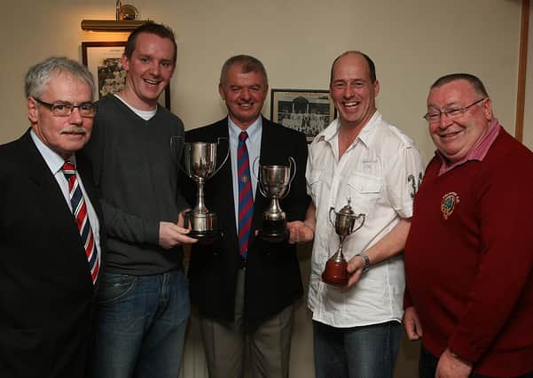 Club director of Cricket Billy Henderson (centre), presents trophies at the Eglinton Cricket Club's annual awards to 1st XI team members Richard Stewart, Bowling award and Andy Christie, Batting award.  Included are Alan Montgomery (left), club president and Robin Glenn, chairman. LS48-537MT.
