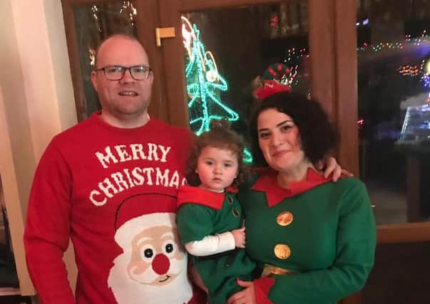 Elena Lynn, husband Geoff and daughter Esther enjoying Christmas last year
