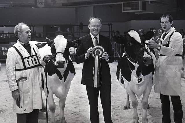 David Heenan, left, of Barbican Farms, Newcastle, and David McClurg of Crossgar ties in the reserve inter-breed championship at the Winter Fair in December 1987. Included is Sam Torrens, chief executive designate, Northern Bank, sponsors of the fair. Picture: Farming Life archives