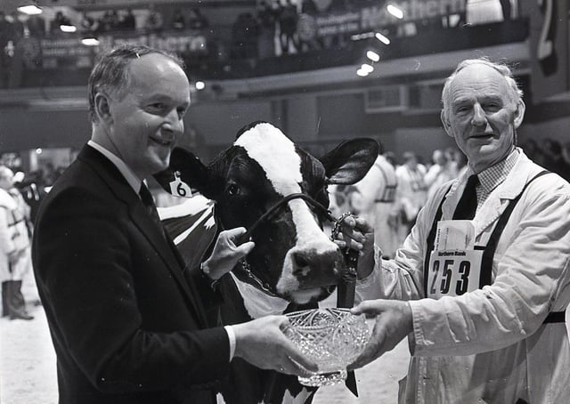 Robert Mulligan, left, from Banbridge receives the inter-breed championship award from Sam Torrens, chief executive designate of the Northern Bank, sponsors of the Royal Ulster Agricultural Winter Fair in December 1987. Picture: Randall Mulligan/Farming Life archives