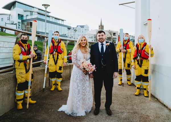 Lauren and Jason Chambers pictured with Portrush RNLI crew members from left, Johnny Weston, Andy McClelland, Tim Nelson and Lisa Abernethy. Wedding photo courtesy of Mairéad McDaid (Remain In Light Photography - www.remaininlightphotography.com).