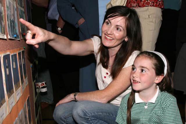 All Saints Primary School pupil Orla Gordon and her mum Moira look at some of the old photos on display at last week?s celebration evening in the school. BT26-121JC