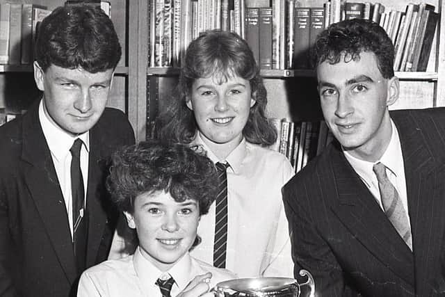 Speaking at the annual prize distribution held in December 1988 at Ballycastle High School in Co Antrim the principal Mr Desmond McKeown said that government policy had forced schools into a position where “it is not just sufficient to compete in terms of sport, but to compete for existence”. The special speaker at the ceremony was Presbyterian Moderator Dr Godfrey Brown, who was accompanied by his wife. Maths cup winner Gillian McAllister shows her trophy to award winners Raymond Colgan, Rosemary Brown and Geoffrey McMullan. Picture: News Letter archives