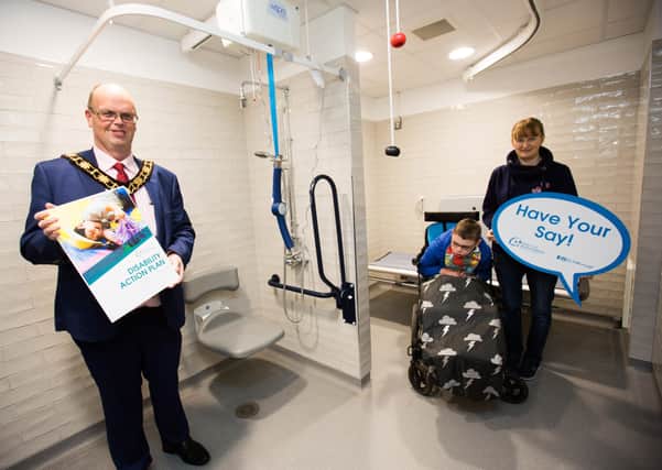Mayor of Antrim and Newtownabbey, Cllr Jim Montgomery with Elaine McBride and her son Sam at the new Changing Places facility at The Gateway in Antrim.