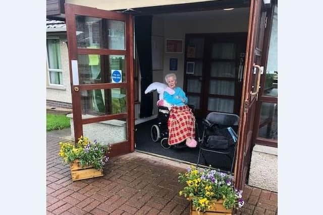 Martina visits her mother Ursula on the front porch of Sandringham Care Home in Portadown.