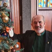 Rev Dr Colin McClure hangs soap on his Christmas tree.
