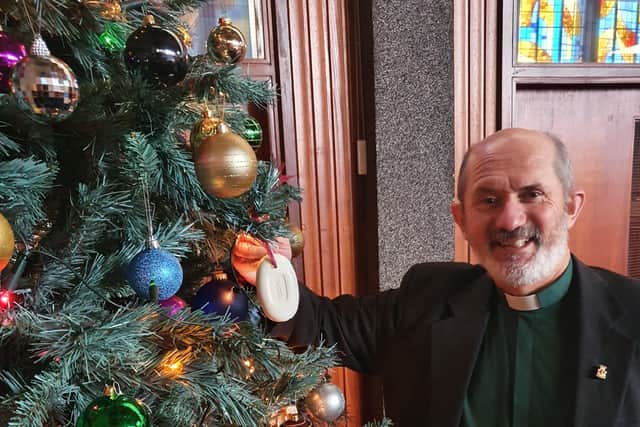 Rev Dr Colin McClure hangs soap on his Christmas tree.