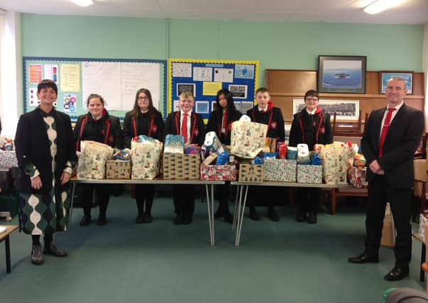 Principal Mr Marsh and Vice-Principal Madame Skobel pictured with students from 11GO who donated hampers of food to the local community as part of their Prince’s Trust course