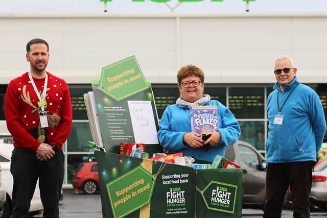 William Brown (left), general store manager, Asda Larne, with  Joan Erwin, chair and Alex Munro, hon. sec., both Larne Foodbank.
