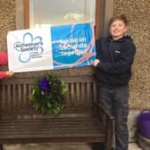 Harry and Molly Lyttle, from Kells, celebrate raising £745.05 for Alzheimer’s Society by creating Christmas Wreaths for their friends and family.