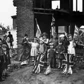 London residents celebrating VE-Day, (Victory-in-Europe Day) marking the end of the war in Europe, amidst the ruins of their home in Battersea, in May 1945. Picture: PA Wire