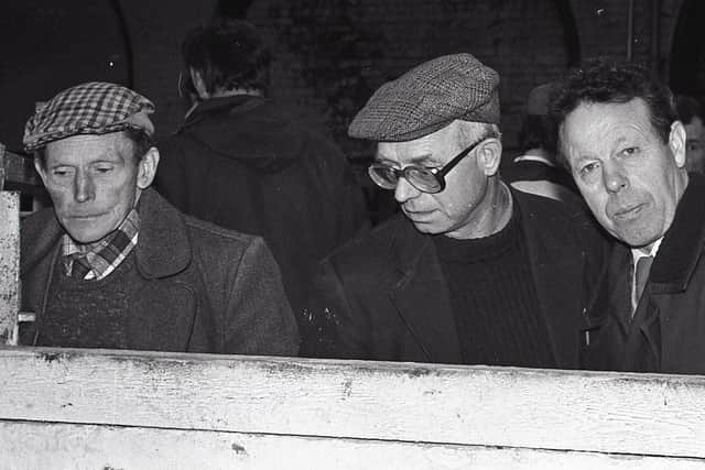 Three exhibitors take a more serious view of matters at the show and sale of prime lambs at Allam's Mart in Belfast in December 1988. Picture: Eddie Harvey/Farming Life archives
