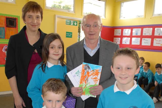 Mr Barr retired after 7 years as caretaker of Corran Integrated Primary School. Pictured above making a presentation to him at assembly are Scott, Conor and Jodie and principal Mrs McFarlane. LT14-364-PR