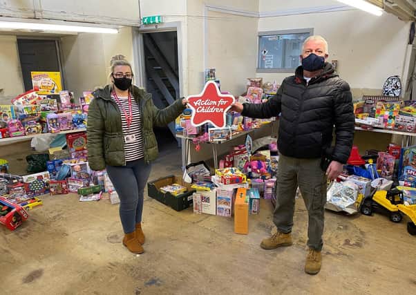 Roger Glasgow fills a van full of Christmas gifts for local children who would otherwise have missed out