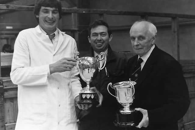 Trevor Shields from Kilkeel, Co Down, exhibited the champion Red Star and performance tested boars at the autumn show and sale of pigs held at Balmoral in October 1989. Mr Shields received his cups from Colin Rea, centre, who judged the two sections, and S Duffield Gibson, president of the Royal Agricultural Society. Picture: Randall Mulligan/Farming Life archives