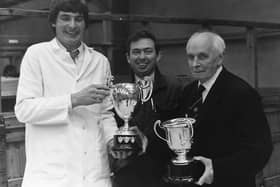 Trevor Shields from Kilkeel, Co Down, exhibited the champion Red Star and performance tested boars at the autumn show and sale of pigs held at Balmoral in October 1989. Mr Shields received his cups from Colin Rea, centre, who judged the two sections, and S Duffield Gibson, president of the Royal Agricultural Society. Picture: Randall Mulligan/Farming Life archives