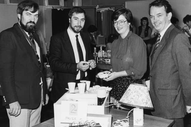 Judy Hulatt from Hillhall YFC sharing the food which contributed to her gaining second place in the finals of the YFCU homemaker competition which was held in Newtownabbey Technical College on Saturday, September 24, 1983. Sampling is Mr C E J Brown, Advances manager who presented the awards, Mr Ken Russell, president of the Young Farmersâ€TM Clubs of Ulster, and Mr John Kelly, agricultural adviser, Allied Irish Banks Ltd, sponsors of the competition. Picture: Farming Life/News Letter archives
