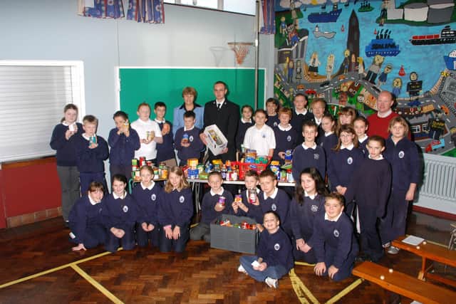 Pupils of the Olderfleet Primary School with Principal Audrey Stewart and teacher Derek Kyle presenting foodstuffs to Nessie Lennon and Daniel Hargey of the Larne branch of the Salvation Army who will distribute  it among the local Larne community.
LT44--001 PSB OLDERFLEET