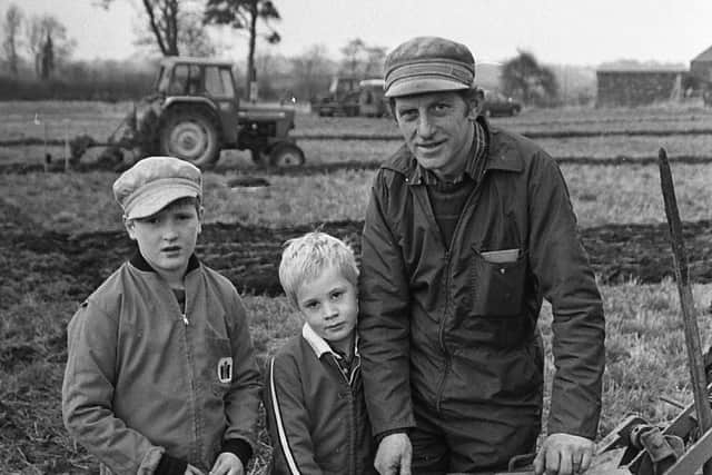 Family team: Samuel Pinkerton from Nutts Corner, Crumlin, Co Antrim, gets some helps from his sons nine-year-old David and Richard, six, during the Drummaul Ploughing Society's annual event at Gracehill, Co Antrim, in December 1988. Picture: Farming Life archives