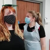 Service user Janine Cousins (left) receives a health check from Health Promotion Student Grace Kennedy dressed in PPE at Action Cancer House in Belfast.
