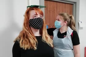 Service user Janine Cousins (left) receives a health check from Health Promotion Student Grace Kennedy dressed in PPE at Action Cancer House in Belfast.