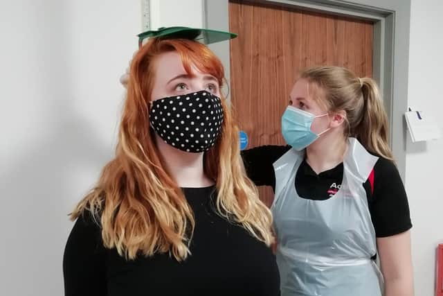 Service user Janine Cousins (left) receives a health check from Health Promotion Student Grace Kennedy dressed in PPE at Action Cancer House in Belfast.