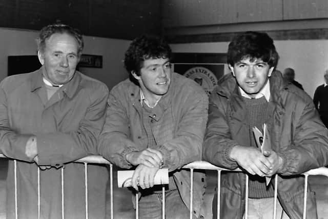 Watching the parade of livestock at the Royal Agricultural cattle and pig events at Balmoral in October 1987 are Harry Patton, left, from Newtownards with his son Wilson, centre, and Sam McCormick from Bangor. Pictures: Eddie Harvey/Farming Life archives