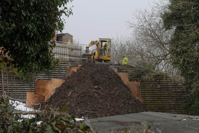 Engineers work on strengthening the retaining wall behind the nursing home after the landslip in 2013.