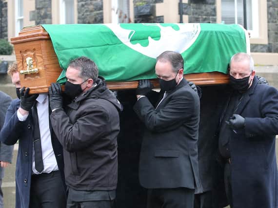 Covered with the Irish Cricket flag the funeral of North West cricketing legend Roy Torrens leaves Portrush Presbyterian Church. Picture by Margaret McLaughlin
