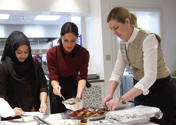Chef Clare Smyth MBE (right) with Meghan Markle (second right) helping out at the Hubb Community Kitchen in London