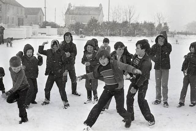 In January 1982 Northern Ireland was lashed by the tail-end of blizzards which has swept in from England. Planes were grounded at Aldergrove, roads were closed, thousands of school children were unable to attend classes or were sent home and once more farmers were struggling to save their upland stock. Electricity supplies were also cut off and sports fixtures badly hit. But the snow in January 1982 wasn't all misery, here children from Glen Primary School, Maghera, Co Londonderry enjoy a snowball fight. Picture: News Letter archives