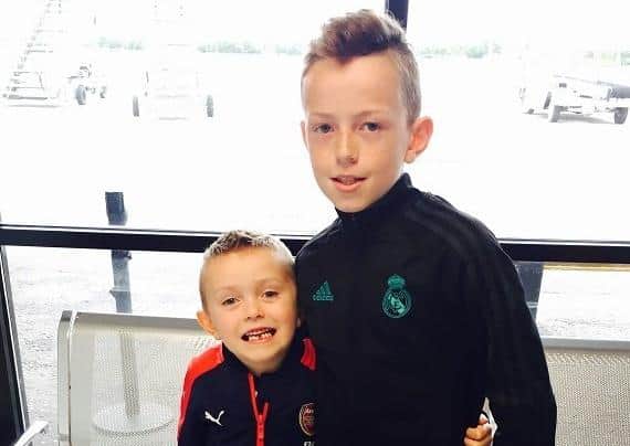 Caden and his brother at the airport about to fly to England to have his transplant