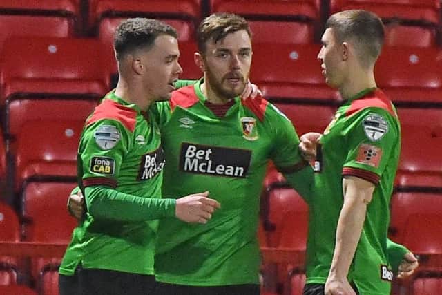 Robbie McDaid (centre) made it 1-1 at Inver Park for Glentoran. Pic by Pacemaker.