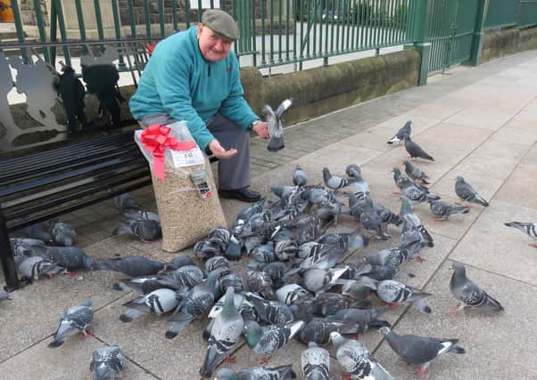 Leslie Harrison feeds the birds out of the special bag that Santa delivered.