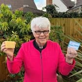 Rev Dr Liz Hughes holds her coronavirus vaccination card and a bar of soap to signify that soap and water remain one of the few defences against infection for people in low-income countries until vaccines are made widely available.