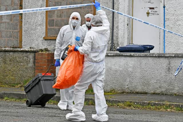 Police forensics officers remove evidence bags from the scene of what the PSNI have described as a â€œsuspicious deathâ€ at a house at Carrickdale Gardens off the Tandragee Road in Portadown, County Armagh. Alan Lewis - PhotopressBelfast.co.uk        10-2-2021