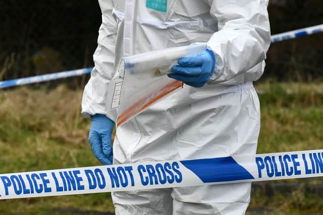 Police forensics officer removes evidence from the scene of what the PSNI have described as a â€œsuspicious deathâ€ at a house at Carrickdale Gardens off the Tandragee Road in Portadown, County Armagh. Alan Lewis - PhotopressBelfast.co.uk        10-2-2021